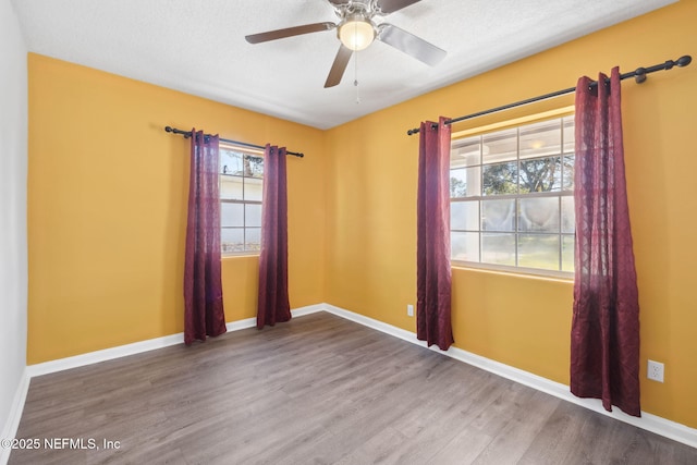 empty room with wood-type flooring, a textured ceiling, and ceiling fan