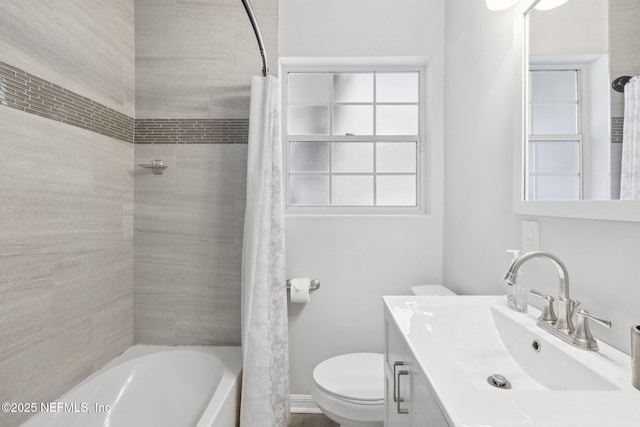 full bathroom featuring shower / bath combo, vanity, and toilet