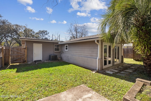 back of property with a yard and cooling unit