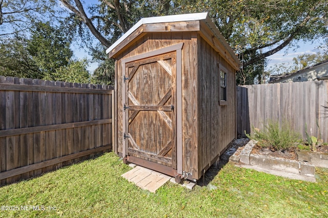 view of outbuilding with a lawn