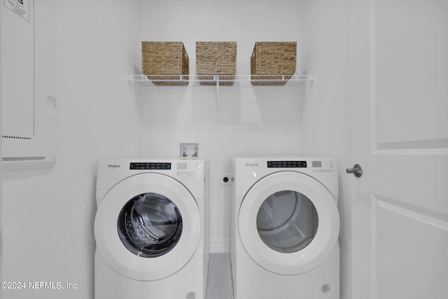 clothes washing area with washing machine and clothes dryer