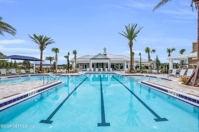 pool featuring a patio, fence, and a pergola