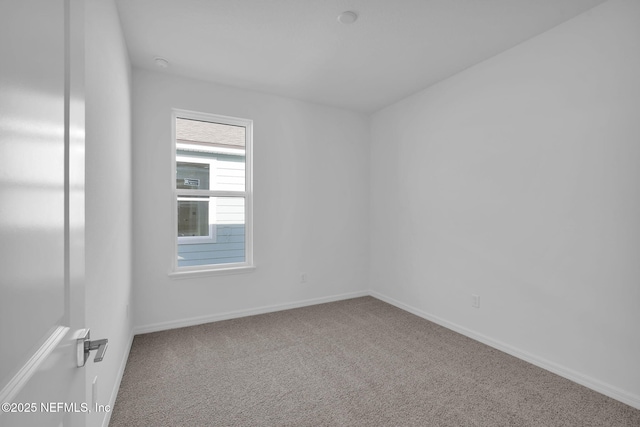 unfurnished room with carpet floors and baseboards