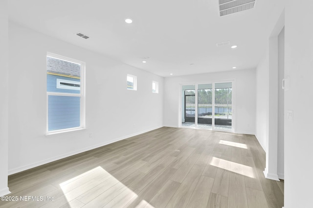 spare room with recessed lighting, baseboards, visible vents, and light wood finished floors