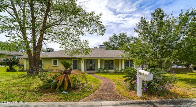 single story home featuring a front lawn