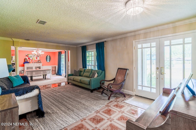 living room with crown molding, an inviting chandelier, french doors, and a textured ceiling