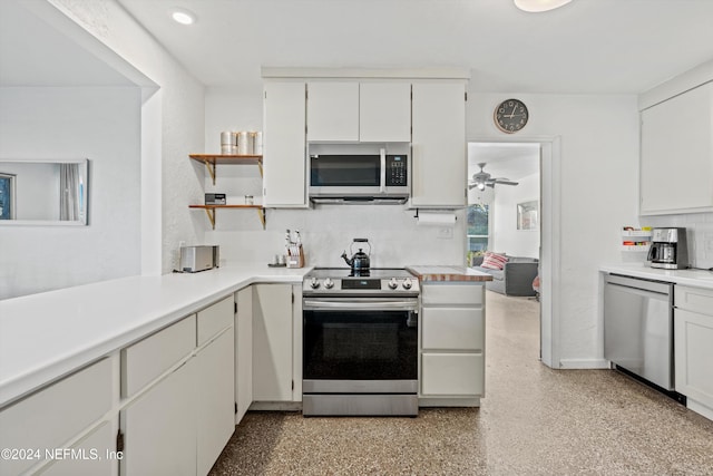 kitchen with decorative backsplash, white cabinetry, ceiling fan, and appliances with stainless steel finishes