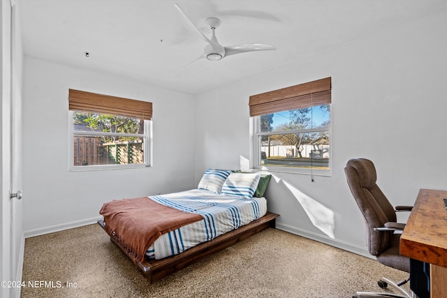 bedroom with carpet, ceiling fan, and multiple windows