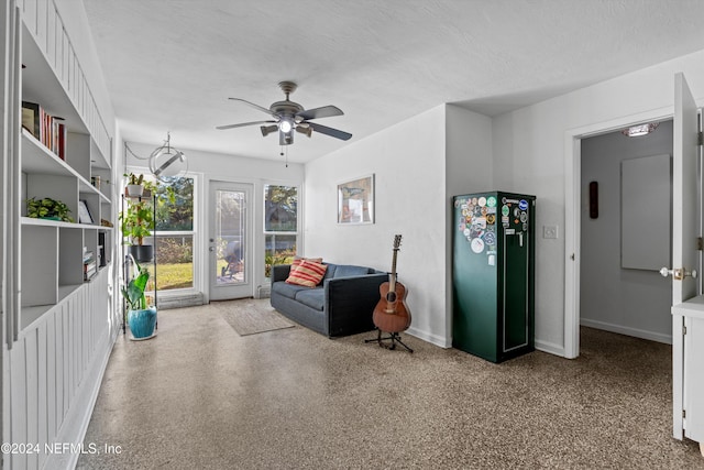 sitting room featuring ceiling fan and a textured ceiling