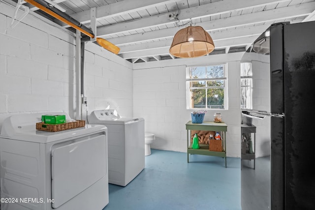 clothes washing area with separate washer and dryer