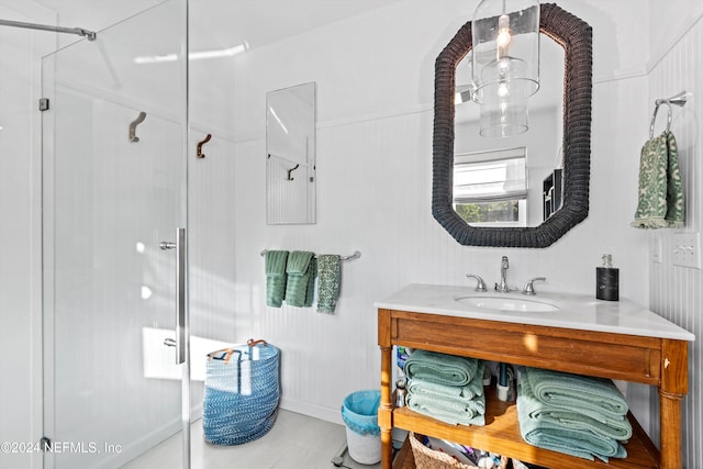 bathroom featuring vanity and a shower with shower door