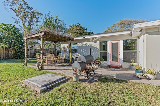 back of house featuring a yard and a patio