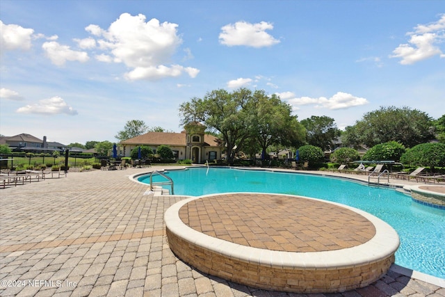 view of swimming pool featuring a patio area