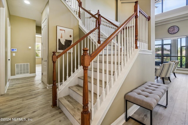 stairs featuring hardwood / wood-style floors