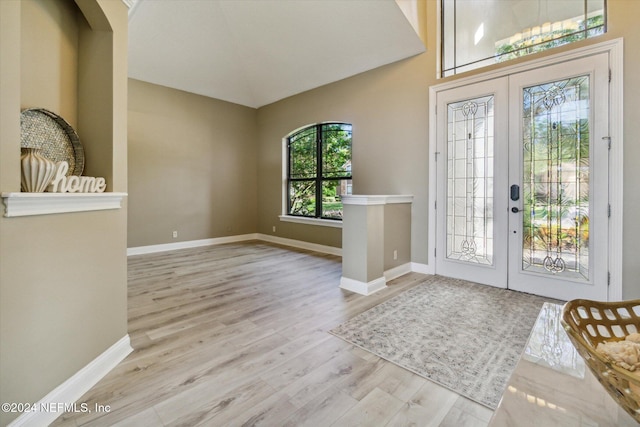 entrance foyer featuring french doors and light hardwood / wood-style floors