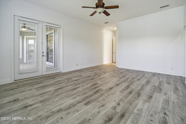 unfurnished room featuring ceiling fan, light wood-type flooring, and french doors