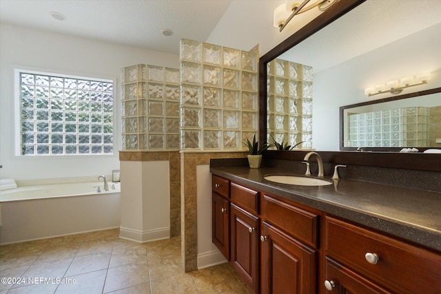 bathroom with tile patterned flooring, vanity, independent shower and bath, and tile walls