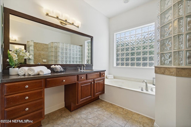 bathroom with tile patterned floors, vanity, and a bath