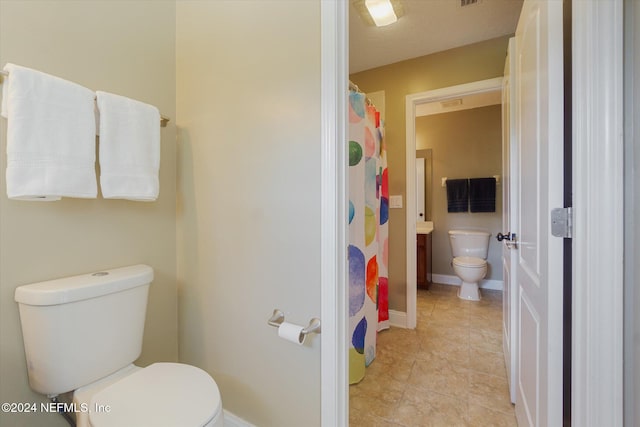 bathroom with tile patterned flooring and toilet