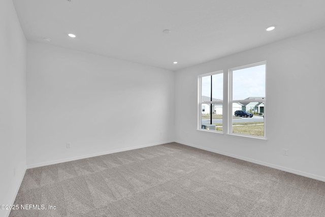 carpeted spare room with recessed lighting and baseboards