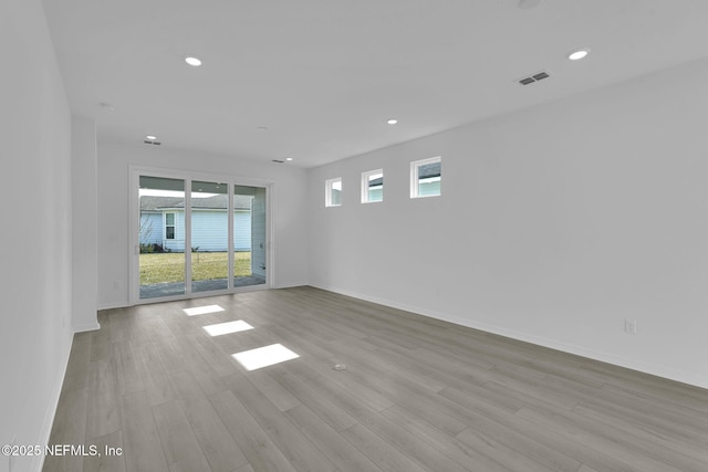 unfurnished room featuring recessed lighting, visible vents, baseboards, and wood finished floors