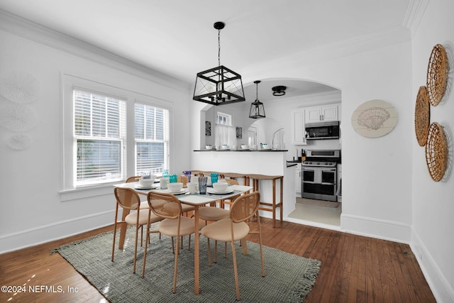 dining room featuring dark hardwood / wood-style flooring and crown molding