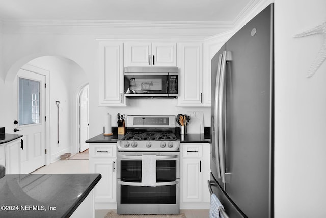 kitchen featuring white cabinetry, stainless steel appliances, and ornamental molding