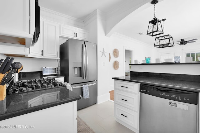 kitchen with white cabinetry, appliances with stainless steel finishes, hanging light fixtures, dark stone countertops, and ceiling fan