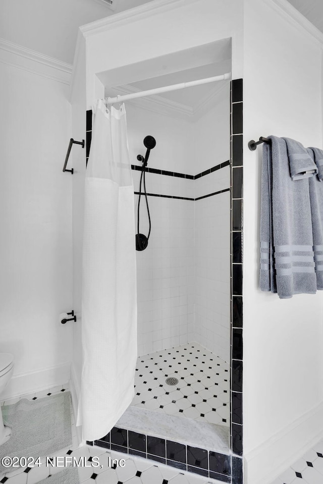 bathroom featuring walk in shower, toilet, and crown molding