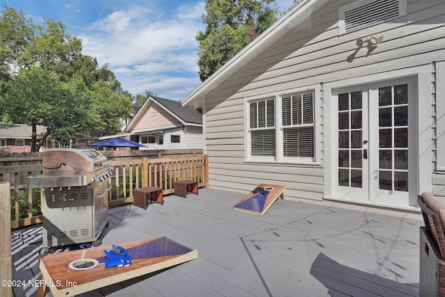 wooden deck featuring grilling area and french doors