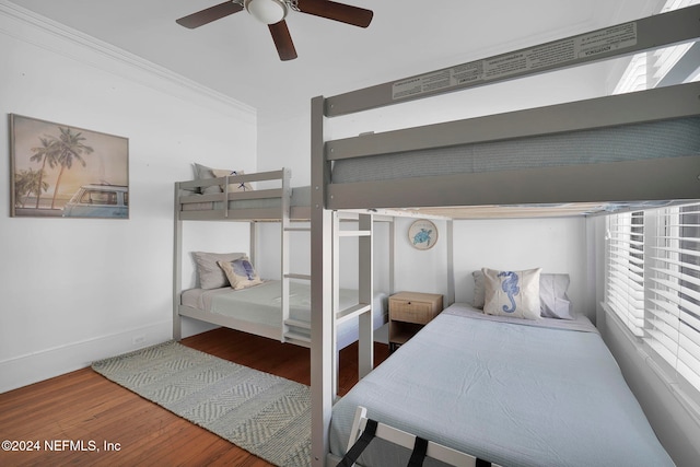 bedroom with crown molding, hardwood / wood-style flooring, and ceiling fan