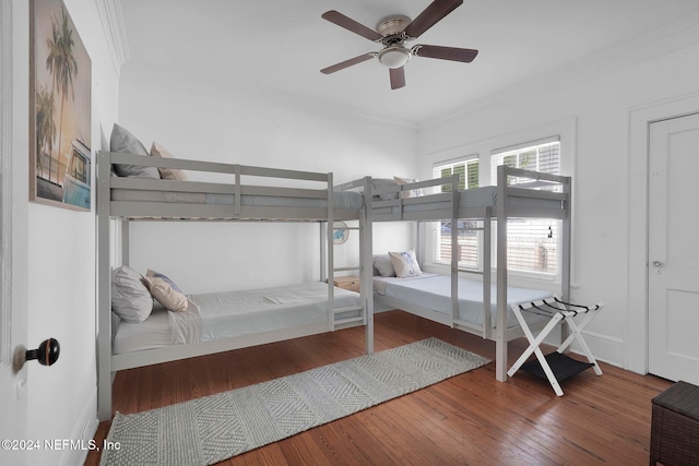 bedroom with hardwood / wood-style flooring, ceiling fan, and ornamental molding