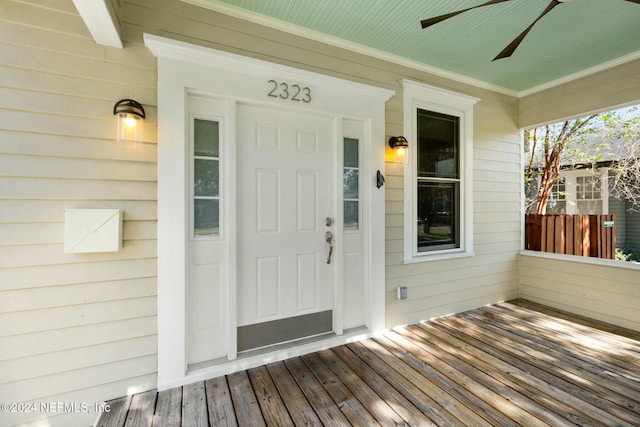 view of exterior entry featuring covered porch