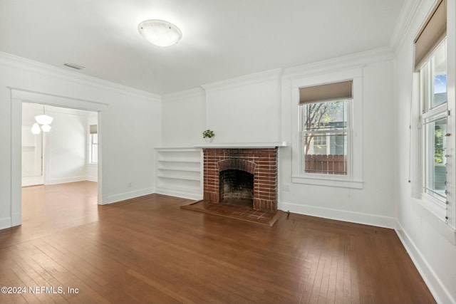 unfurnished living room featuring crown molding, a fireplace, and dark hardwood / wood-style floors