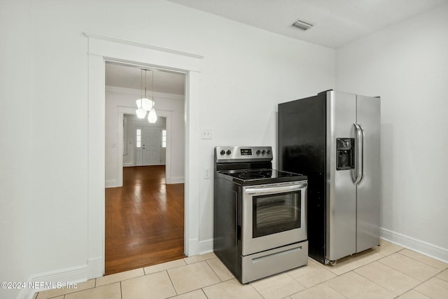 kitchen featuring appliances with stainless steel finishes and light hardwood / wood-style flooring