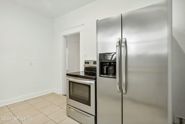 kitchen with light tile patterned floors and stainless steel appliances