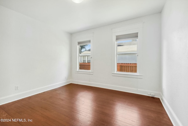 unfurnished room featuring dark hardwood / wood-style floors