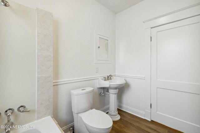 bathroom with hardwood / wood-style flooring and toilet