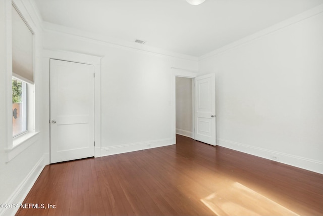 unfurnished room with crown molding and dark hardwood / wood-style floors