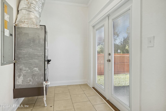 doorway to outside featuring crown molding and light tile patterned flooring