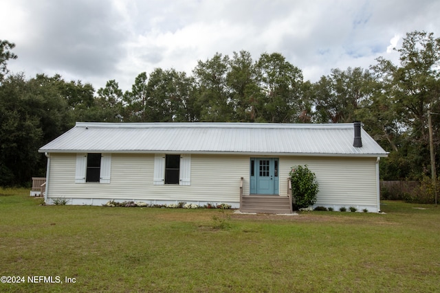 back of property with a lawn