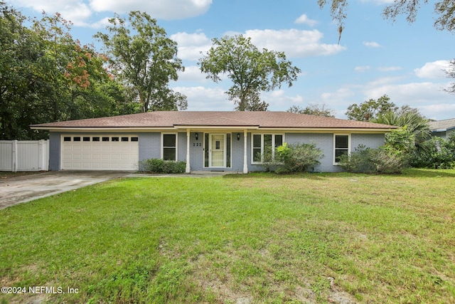 ranch-style house featuring a garage and a front yard