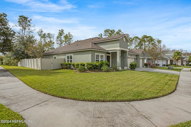 view of front of property with a front lawn and a garage