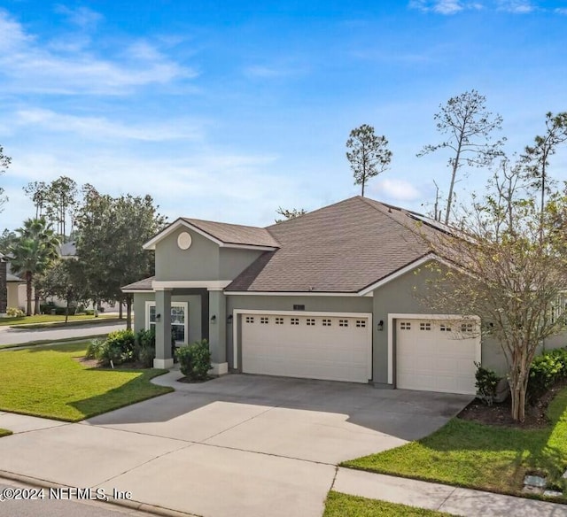 view of front of property with a garage and a front yard