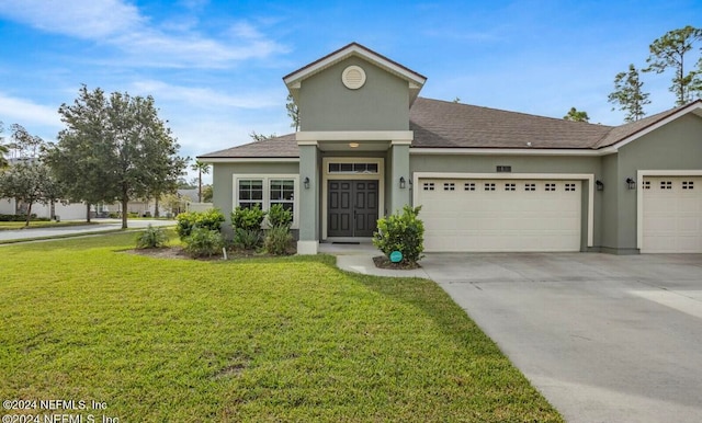 view of front facade with a garage and a front lawn