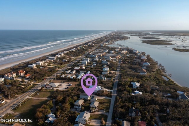 aerial view with a water view and a beach view