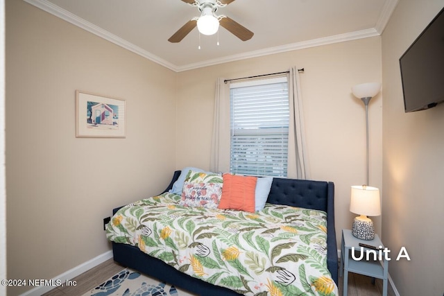 bedroom with hardwood / wood-style flooring, ceiling fan, and crown molding