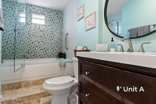 full bathroom featuring enclosed tub / shower combo, vanity, and toilet