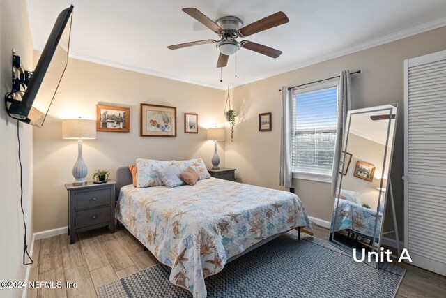 bedroom featuring crown molding, ceiling fan, and light wood-type flooring