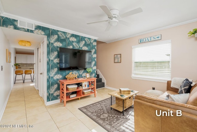 tiled living room with ceiling fan and ornamental molding